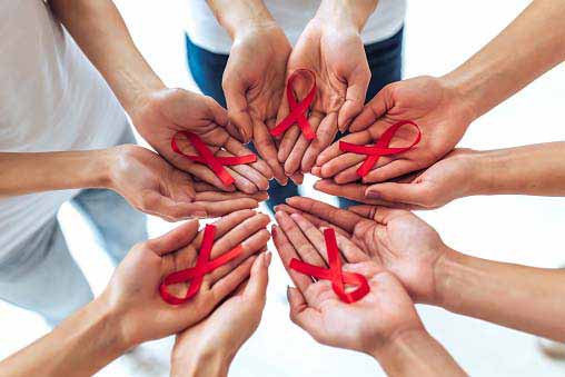 Group of multiracial people with red ribbons in hands.